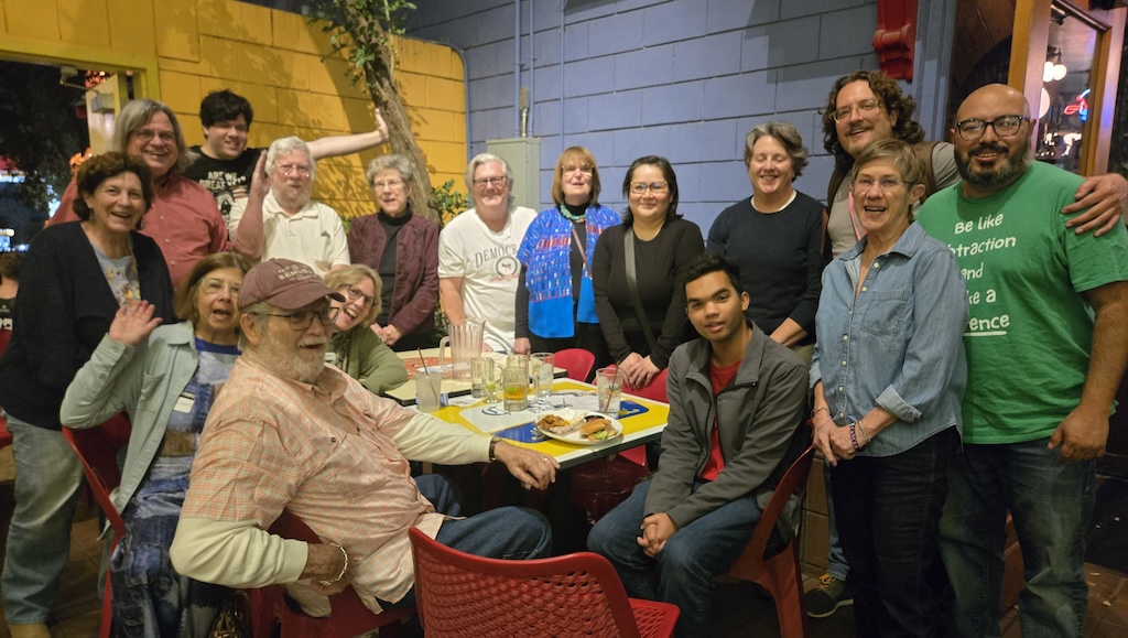 Group of Dems and Friends attendees gathered around tables at a San Antonio ice house